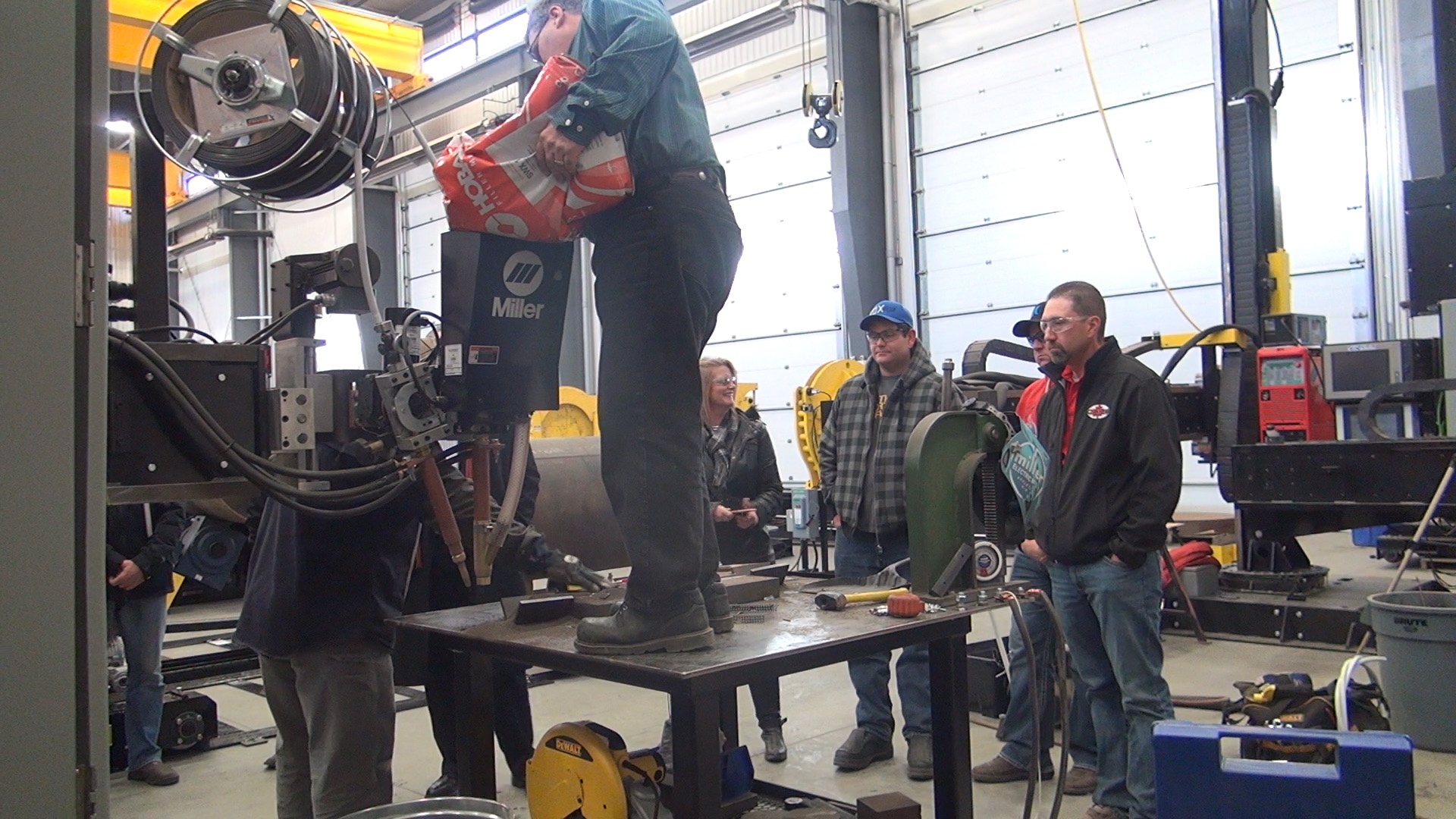 flux being refilled into hopper of the welding manipulator